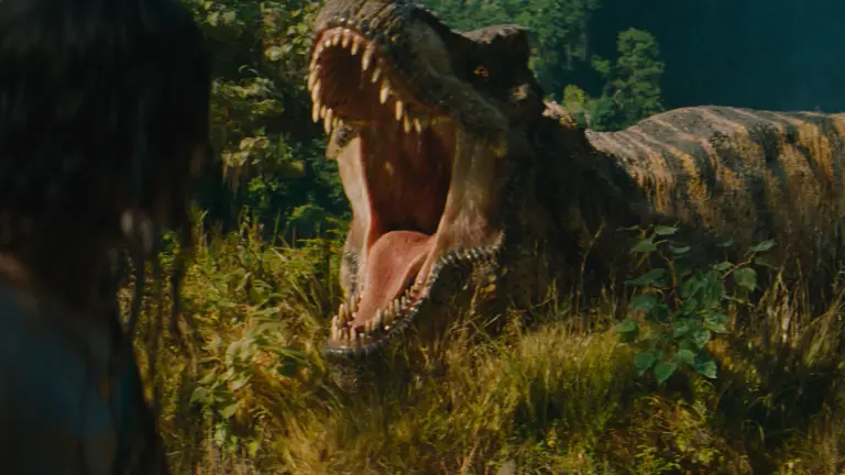 Un parque prehistórico hiperrealista, con un braquiosaurio entre árboles gigantes y un tiranosaurio al fondo, con estética cinematográfica y sin texto sobre la imagen.